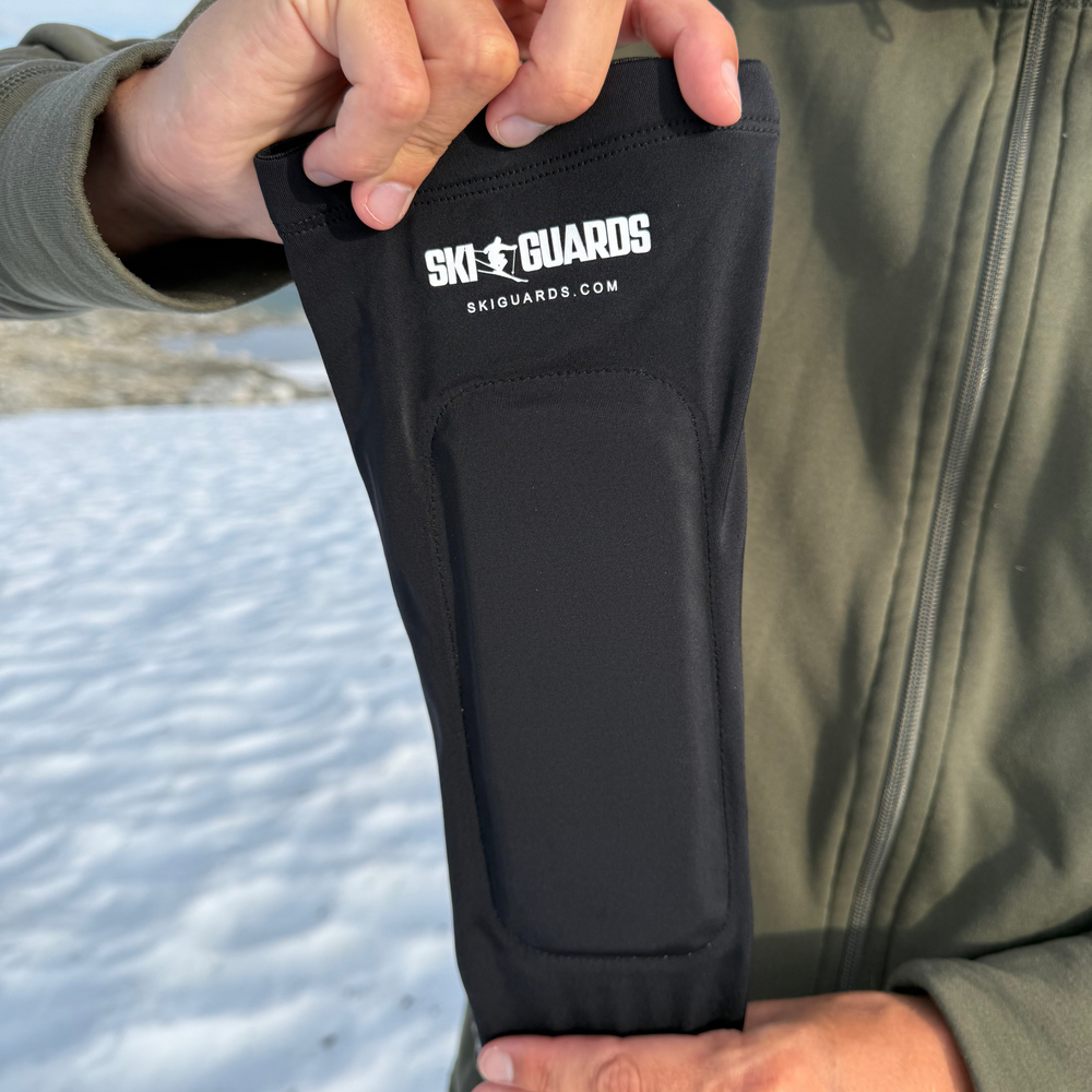 Real SkiGuard Pro textile sleeve held outdoors, showing the flexible fabric and padded panel