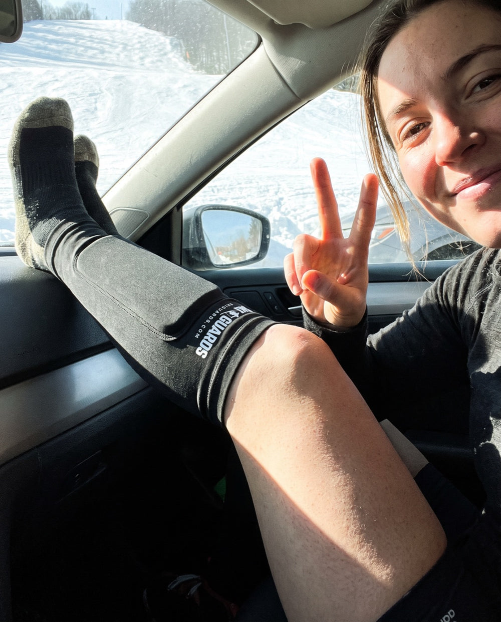 Product-page image of a skier showing a SkiGuard sleeve worn over a sock